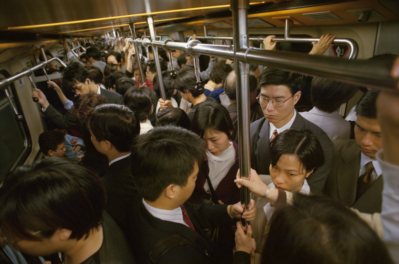 早晨交通尖峰時刻，從九龍到香港的地鐵車廂內擠滿通勤人潮，這是觀眾在生活中面對的現實，也是電影中走過富貴奇幻之旅主角們無法逃離的逼人現實。（攝影／Wally McNamee／Getty Images）