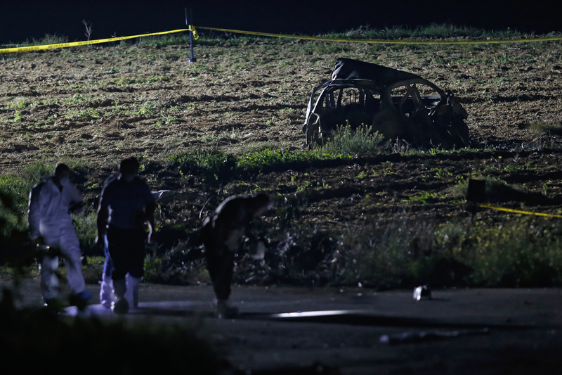 On October 16, 2017, forensic experts collected evidence near the vehicle where Daphne was targeted in a bomb attack. (Photo by Darrin Zammit Lupi/REUTERS)