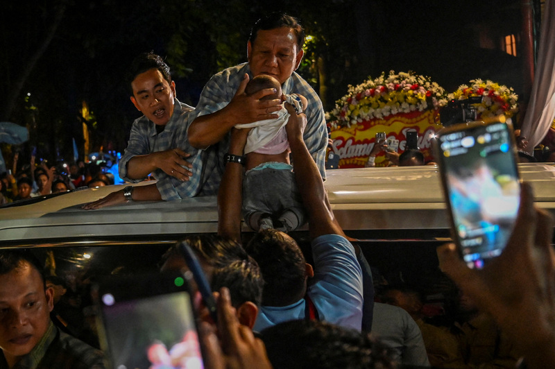 During the 2024 Indonesian presidential campaign, then-Defense Minister and presidential candidate Prabowo Subianto sought to overturn his image as a strongman leader. The photo shows Prabowo kissing a baby and greeting supporters during a campaign parade on the streets of Jakarta. (Photo by Antara Foto/Erlangga Bregas Prakoso via REUTERS)